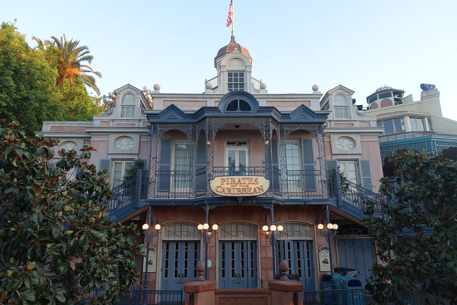 The pink New Orleans-style building with blue iron balconies that forms the ride entrance